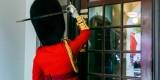 Officer with ceremonial sword banging on the door of city hall 