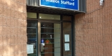Entrance doors to Stafford Studios set inside and next to a brick wall