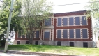 The former Broadview School is a two storey red brick building with a flat roof and limestone details. The building is located in the Highland Park neighbourhood. 