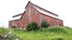 The Bradley-Craig Barn is a large wooden dairy barn with a distinctive monitor roofline located at 590 Hazeldean Road.